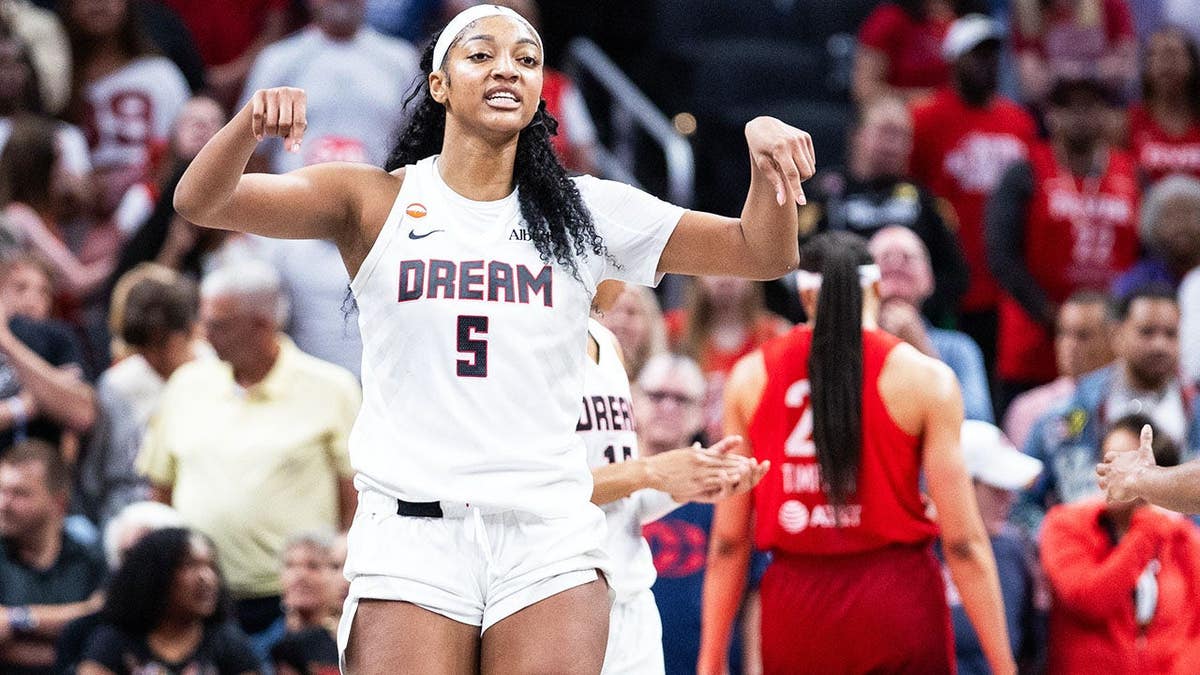 Angel Reese celebrating a basket during a basketball game at Gainbridge Fieldhouse.