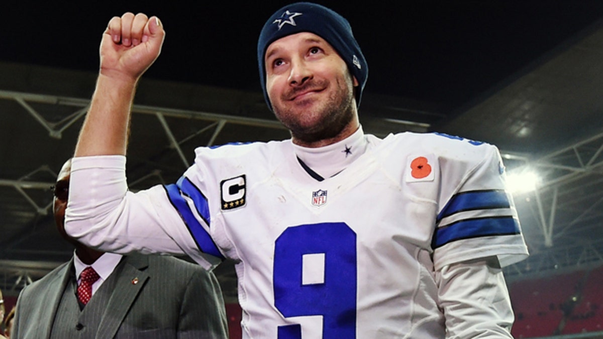 FILE - In this Nov. 9, 2014, file photo, Dallas Cowboys quarterback Tony Romo acknowledges spectators after the team's 31-17 victory over the Jacksonville Jaguars in an NFL football game at Wembley Stadium in London. (AP Photo/Tim Ireland, File)
