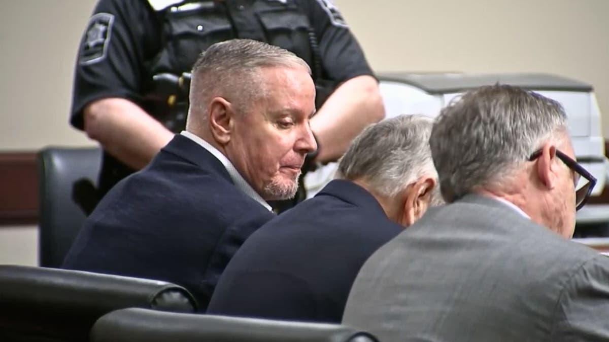 Colin Gray seated in court looking down as guilty verdict is read.