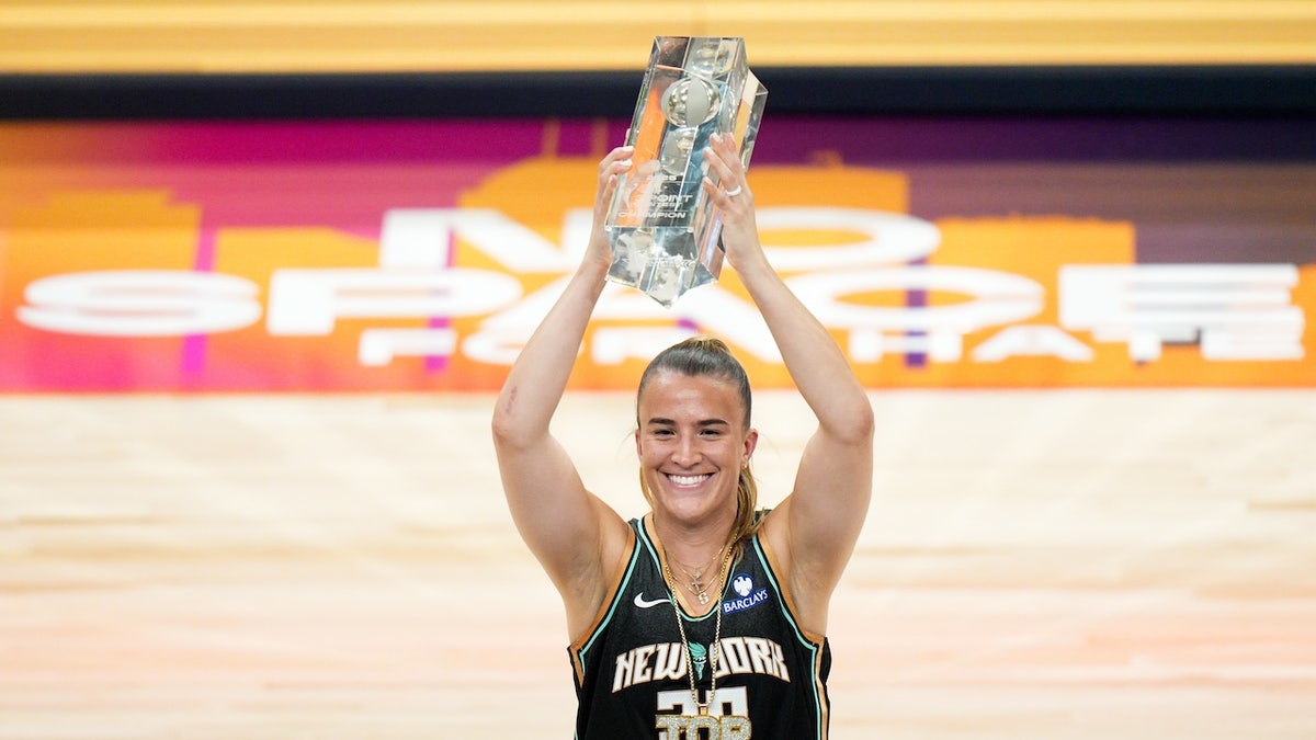 Sabrina Ionescu celebrates after winning a competition