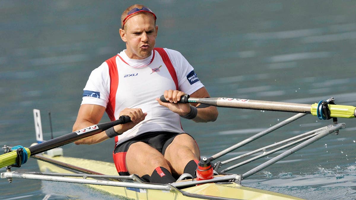 Olaf Tufte competes in a single sculls rowing boat during competition.