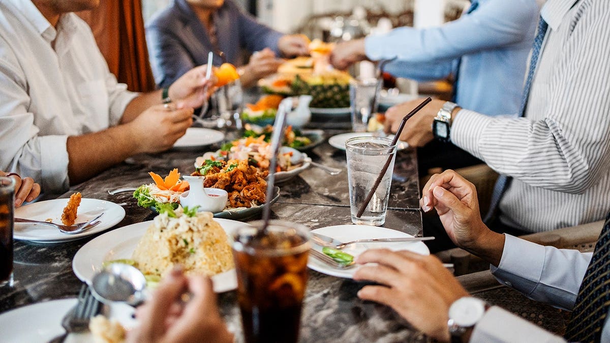 Business professionals seated together at a restaurant table during dinner