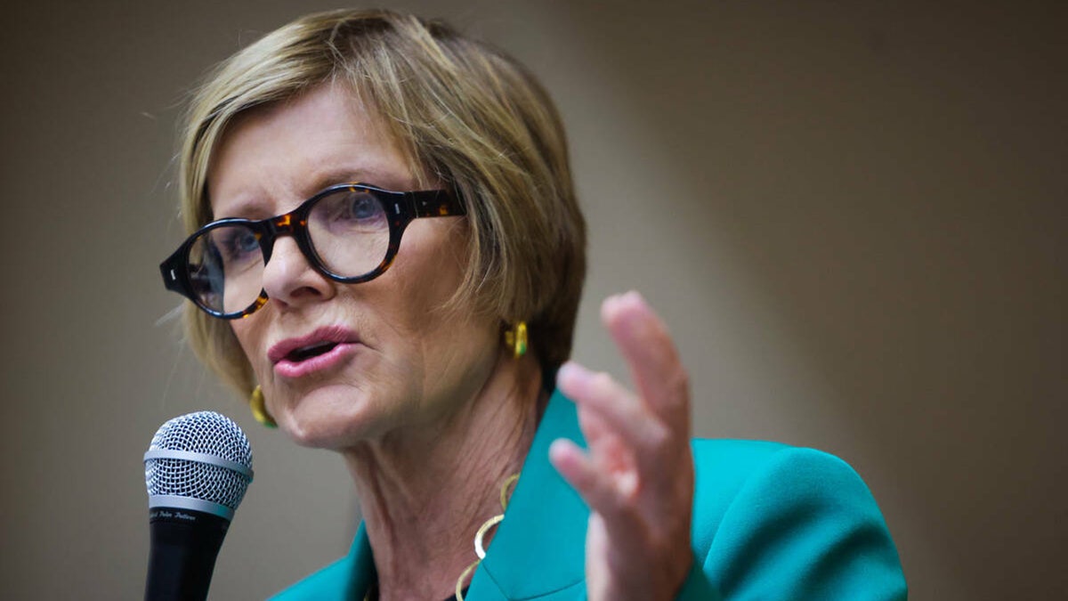 Rep. Susie Lee speaks while holding microphone