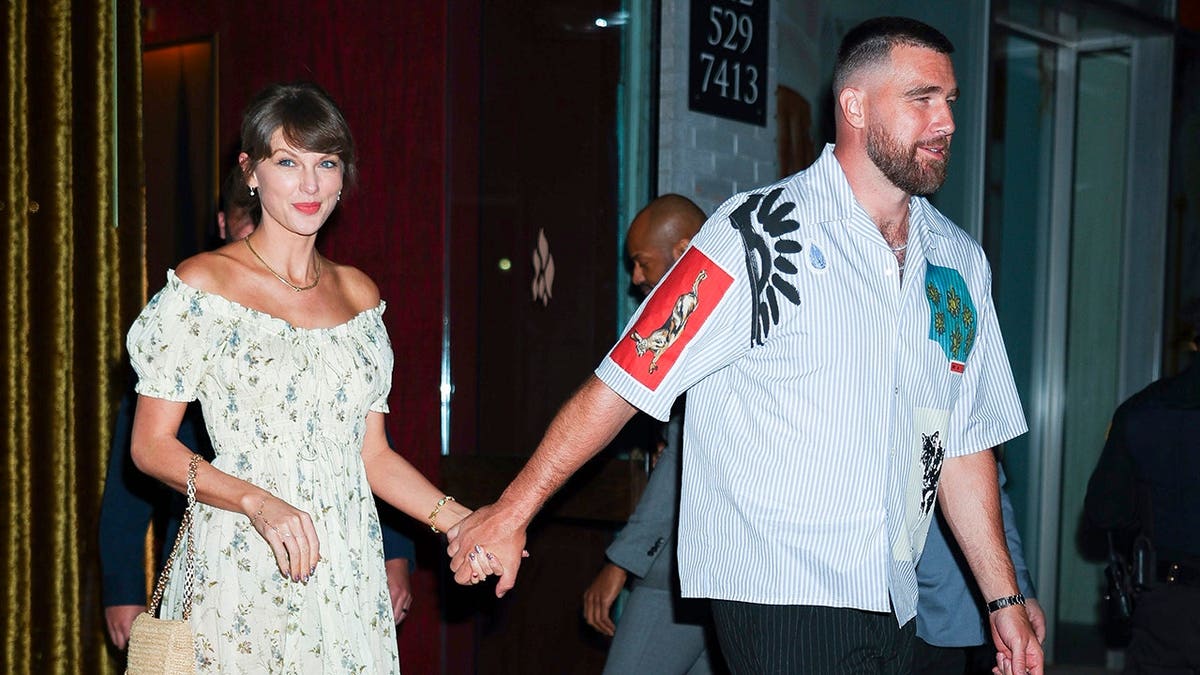 Taylor Swift and Travis Kelce standing together in New York City