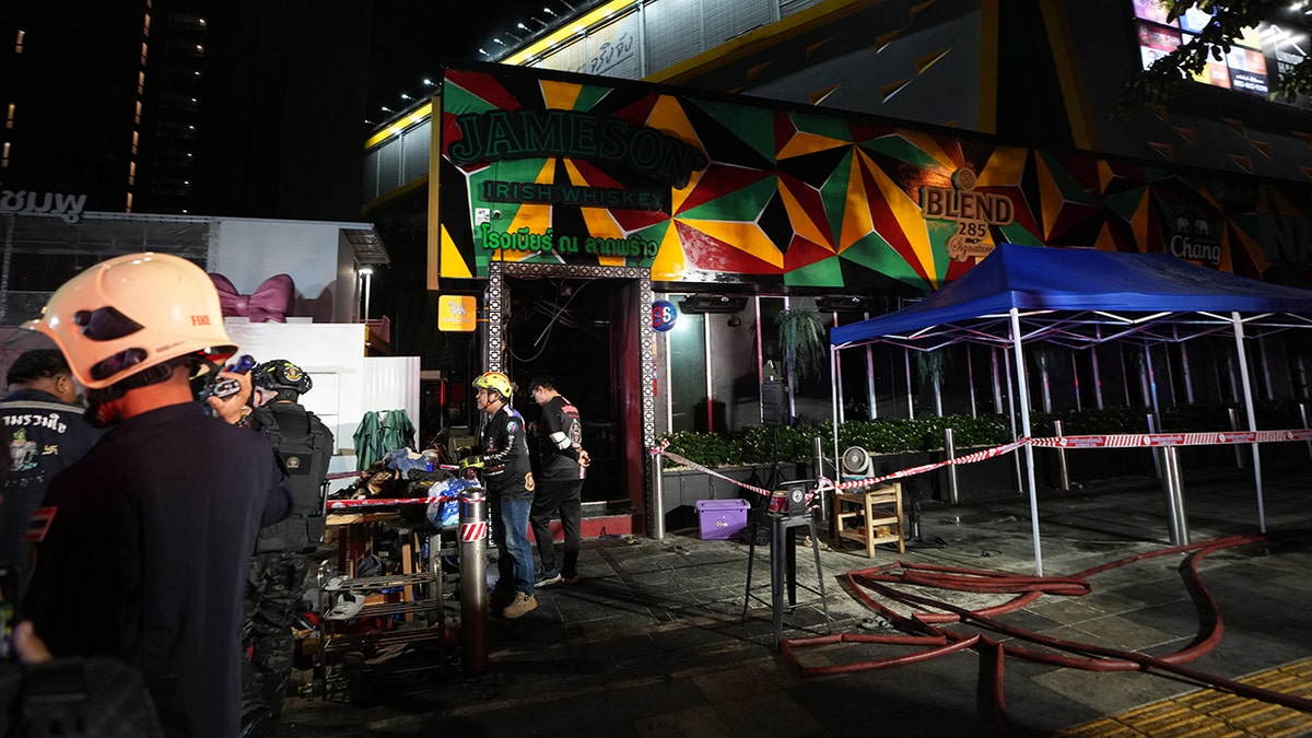 Rescuers work at the site of a fire in Bangkok