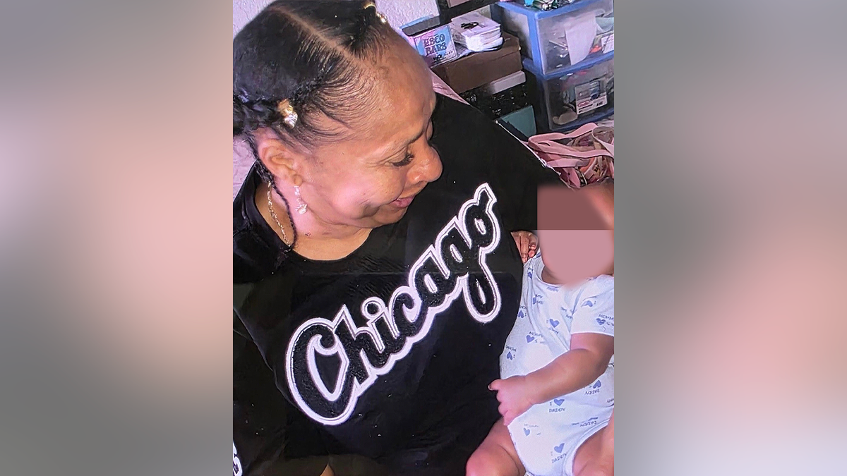 Theresa Jones holds a baby in a family photo shared after her death