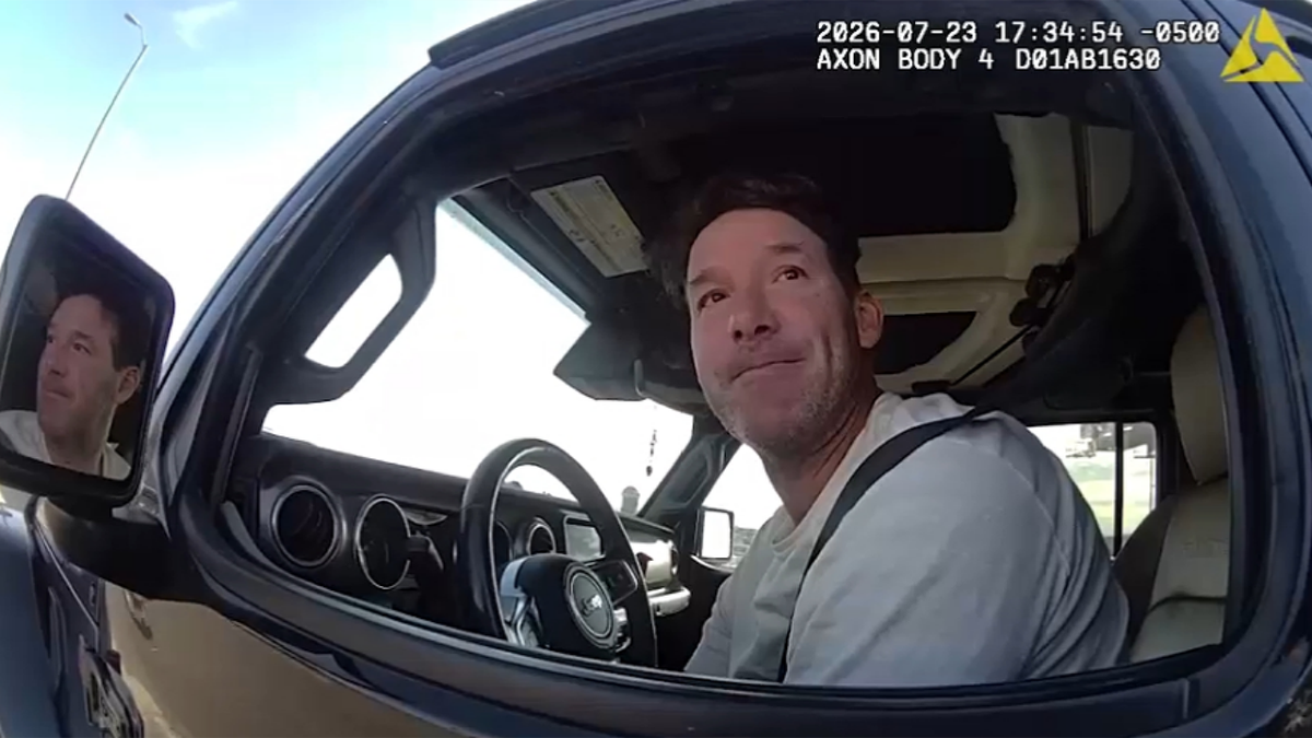 Tony Romo speaks to officers