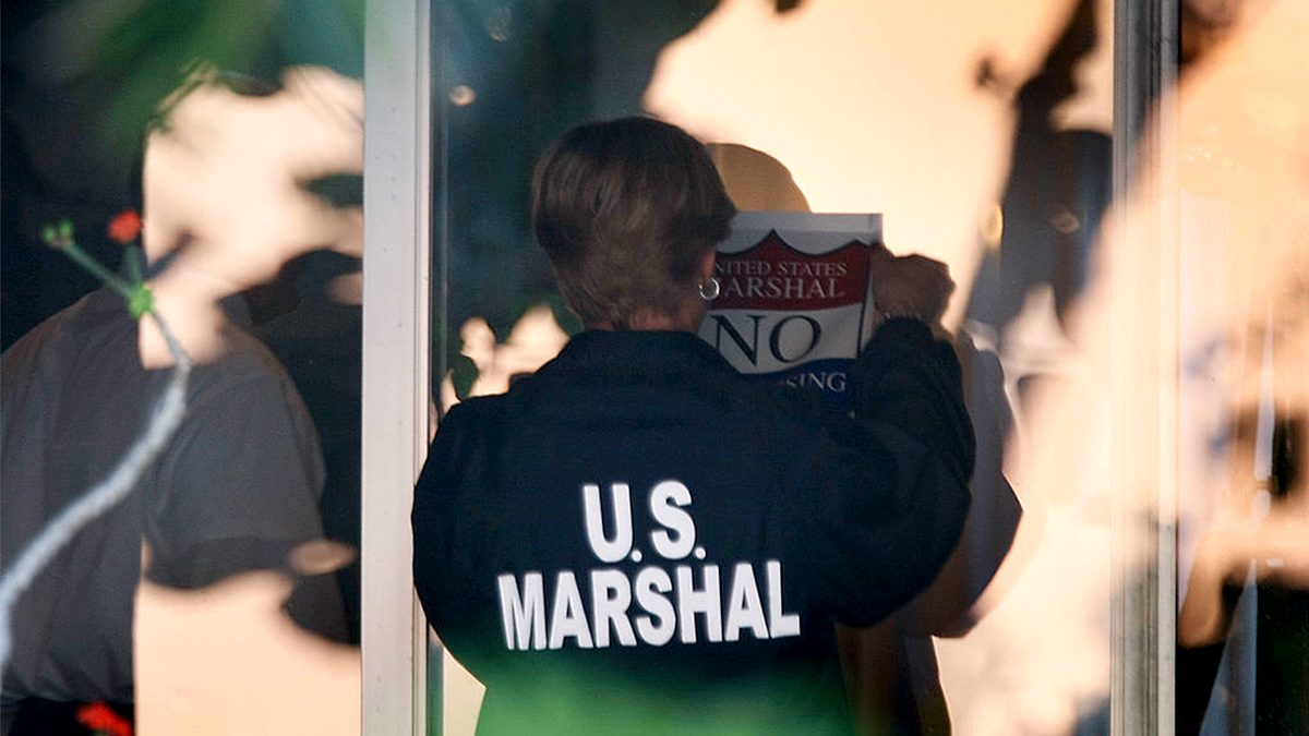 U.S. Marshal near a door