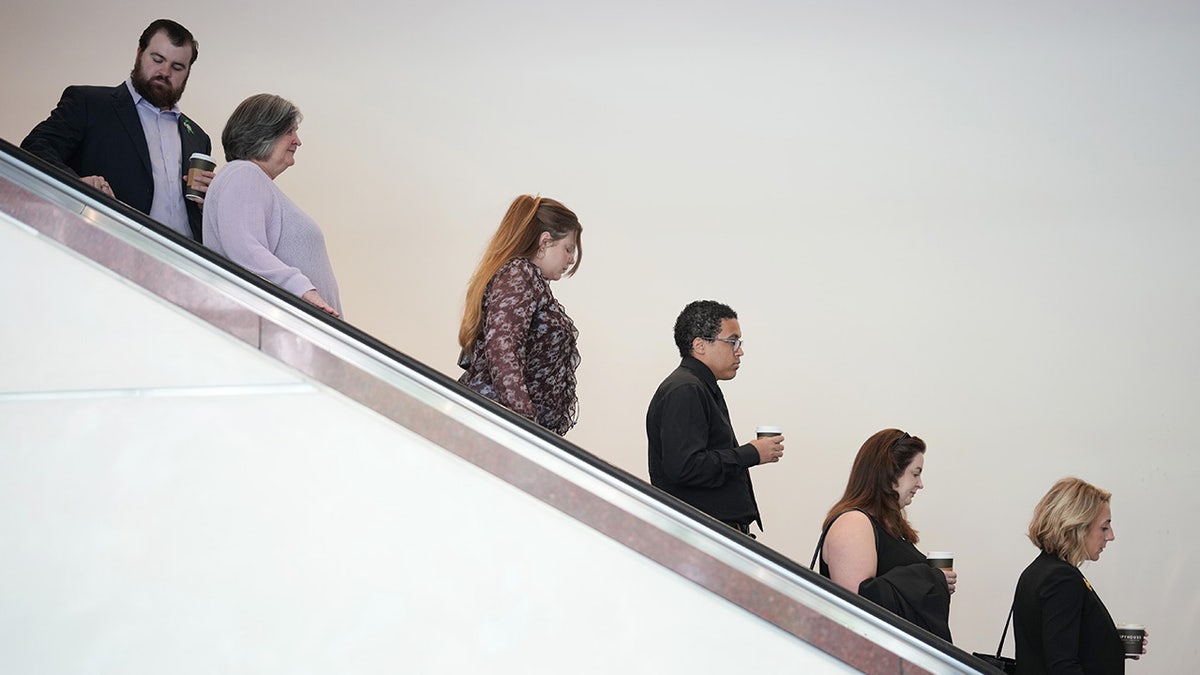 Lawmakers coming down a flight of stairs