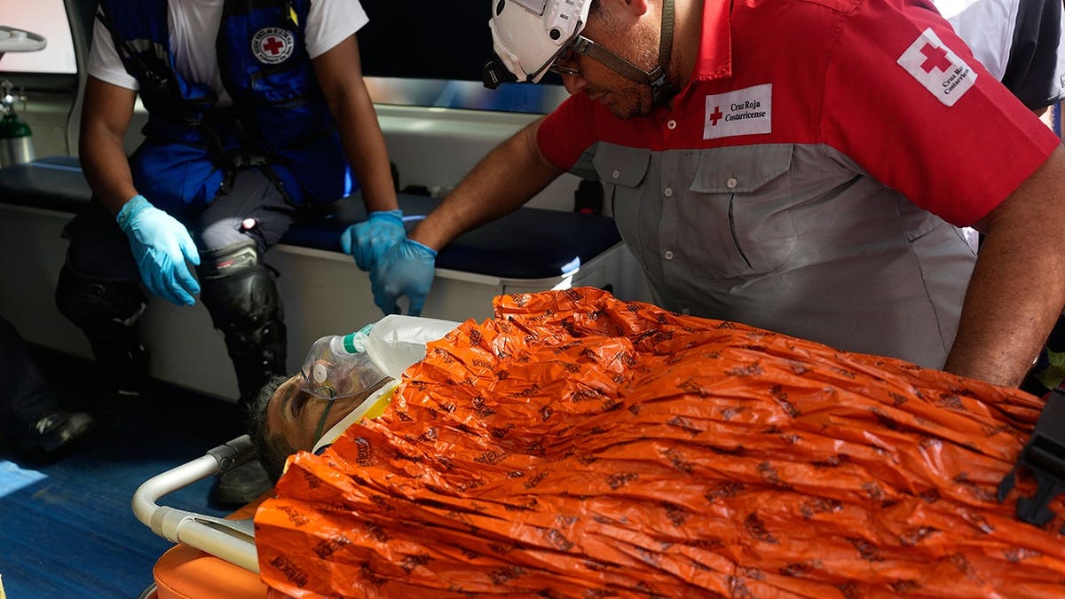 Hernán Alberto Gil Flores on stretcher with emergency personnel
