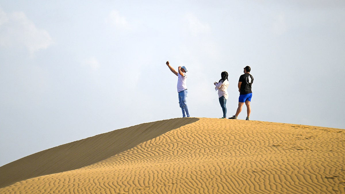 Tourists on sand dune in Venezuela