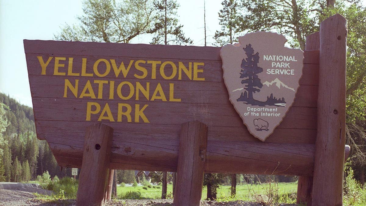 Yellowstone National Park sign stands in Yellowstone National Park, Wyoming.