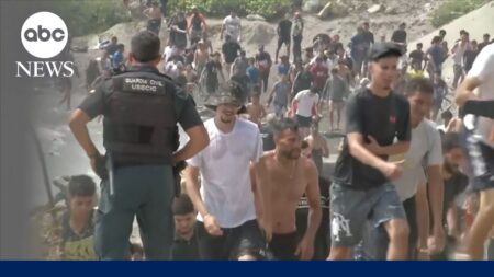 Thousands of migrants surge into Spanish enclave in North Africa