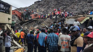 Massive garbage heap collapses onto homes, killing at least 30 as rescuers search for survivors