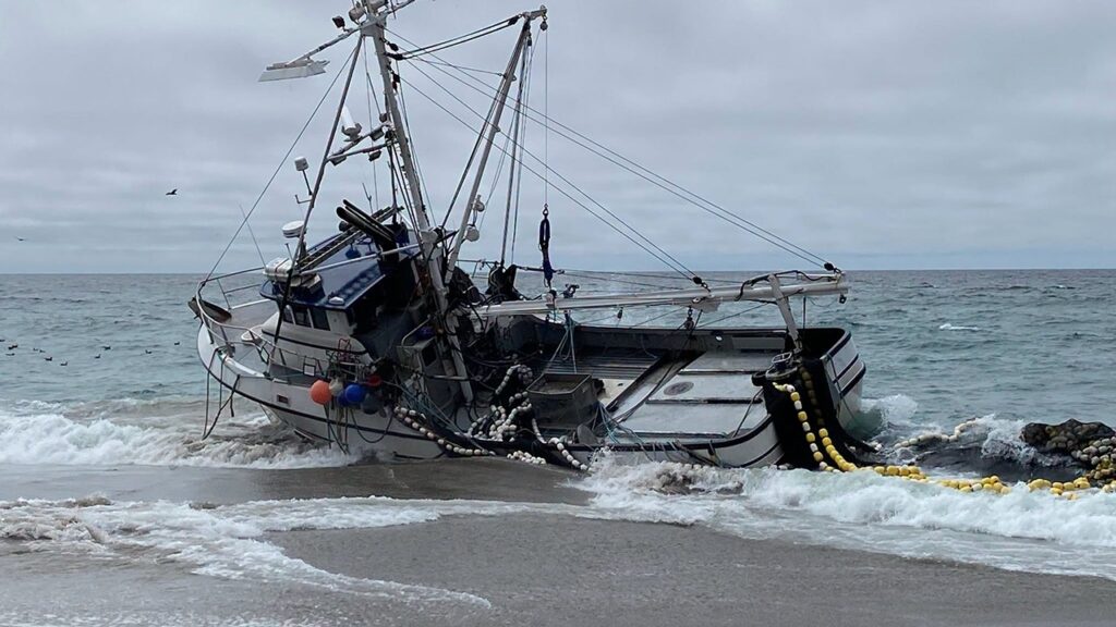 Massive fishing boat runs aground at popular beach with 1,000 gallons of diesel on board