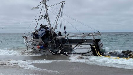 Massive fishing boat runs aground at popular beach with 1,000 gallons of diesel on board