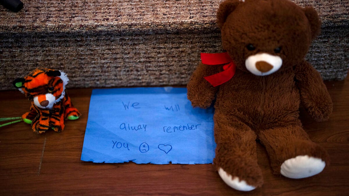 Stuffed animals are left at the altar during a prayer vigil for 10-year-old Iliana