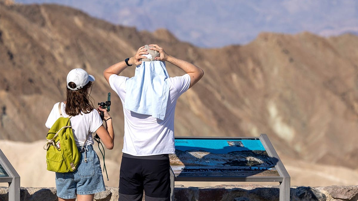 Two tourists standing in heat at Death Valley