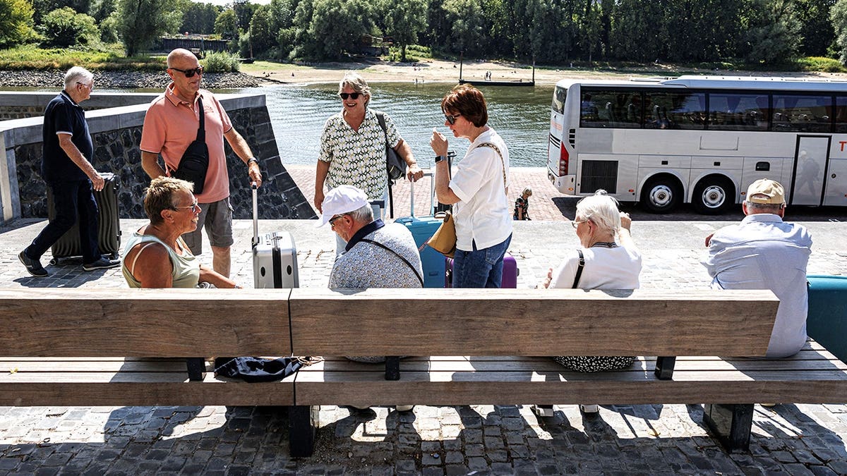 View of cruise passengers being bussed to different locations
