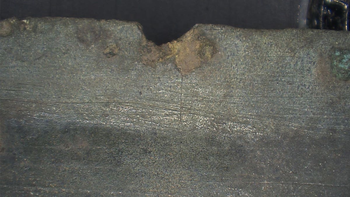 Close-up of damage to ancient sword