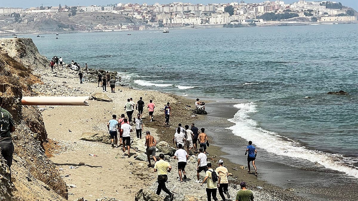 Migrants cross on foot into the North African enclave of Ceuta from Morocco by attempting to swim, according to Spain's Guardia Civil, near the border with Ceuta, in Fnideq, Morocco, July 30, 2026, in this still image obtained by Reuters