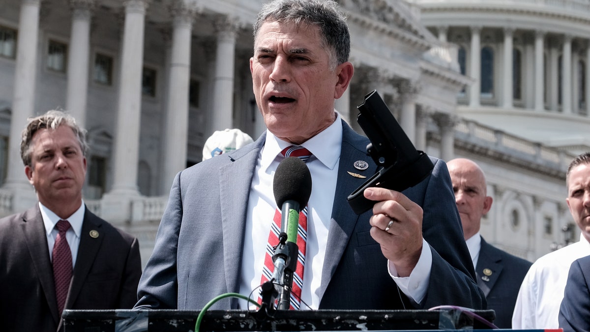 Rep. Andrew Clyde, R-Ga., holds a pistol brace as he speaks to the press during a press conference on Capitol Hill on June 13, 2023 in Washington, D.C.