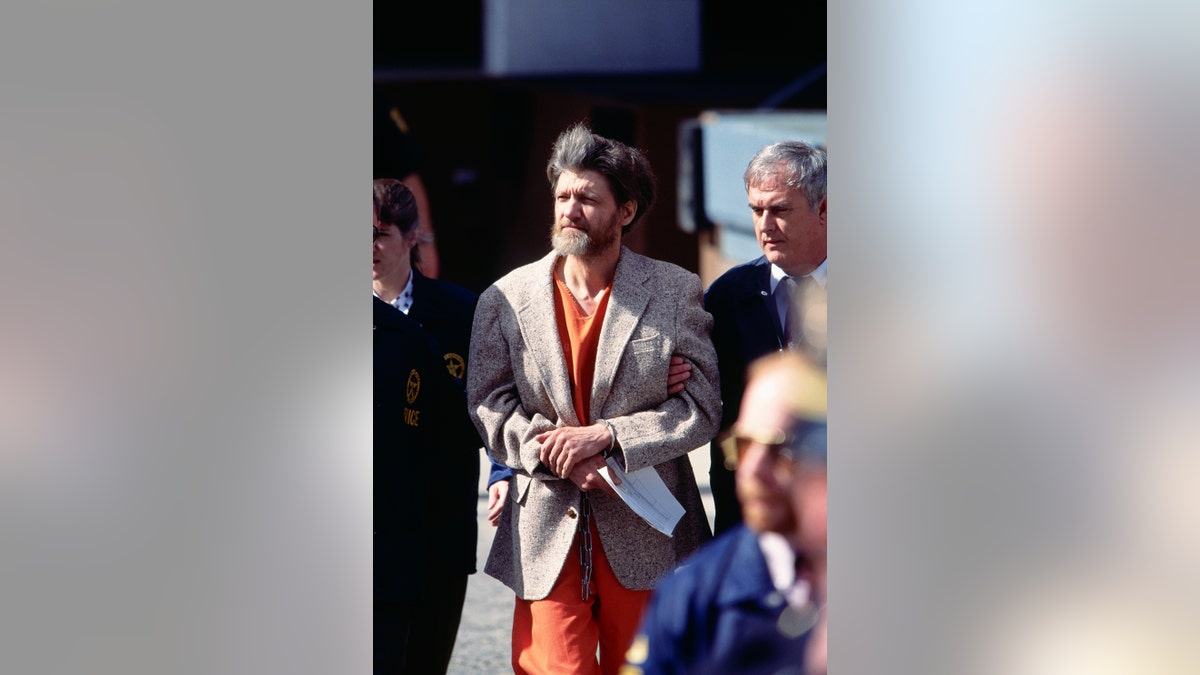 Police officers bring Theodore Kaczynski, aka the Unabomber, to court for arraignment. Kaczynski later pled guilty to the mail bomb attacks that killed three people and injured 23.