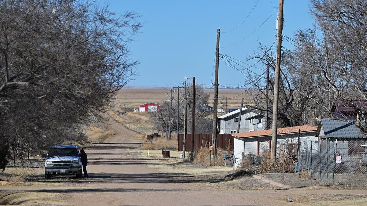 Power lines stretch along First Street in Hartman, Colo.