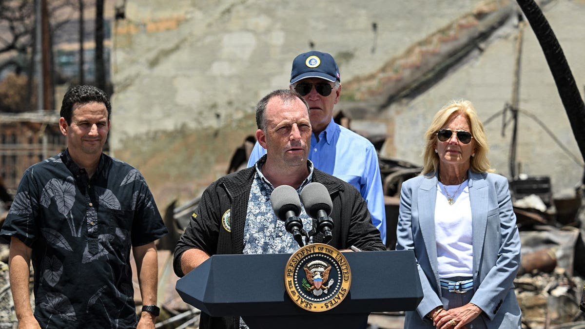 Hawaii Governor Josh Green (C) delivers remarks as US President Joe Biden listens during a visit to an area devastated by wildfires in Lahaina, Hawaii on August 21, 2023.