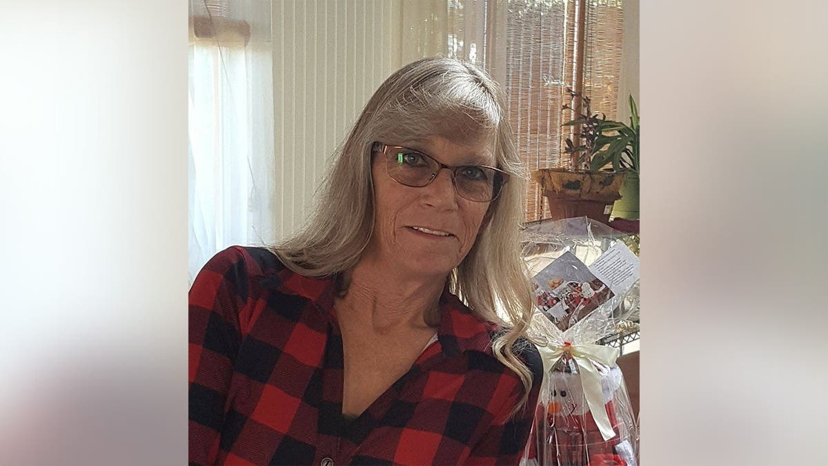 Susan Gehrke in a black and red plaid shirt