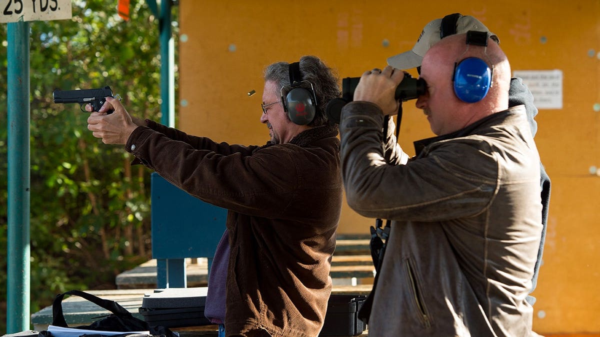 Tom Begich shoots with Mark Kelly