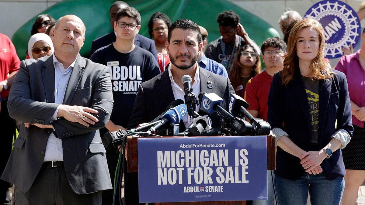Abdul El-Sayed speaks at a press conference flanked by Mallory McMorrow and Curtis Hertel Jr. in Detroit.
