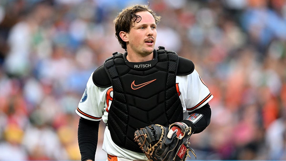 Adley Rutschman #35 catches for the Baltimore Orioles against the Kansas City Royals.