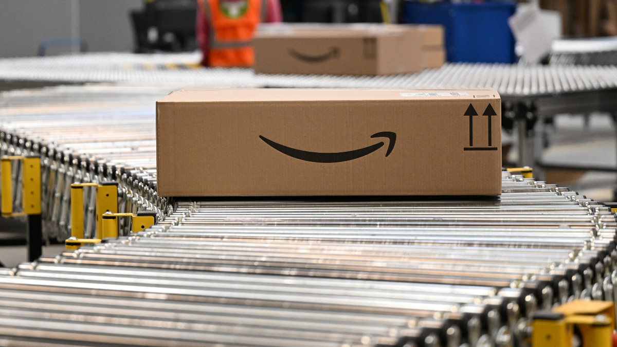 A package with the logo of Amazon is transported along a conveyor belt at a packing station of a redistribution centre of US online retail giant Amazon.