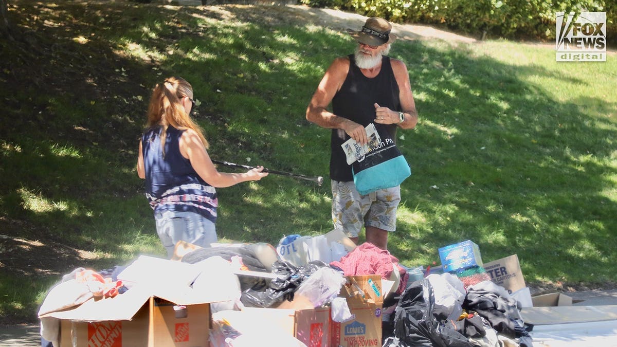Brian Hooker rummages through neighborhood trash in California.