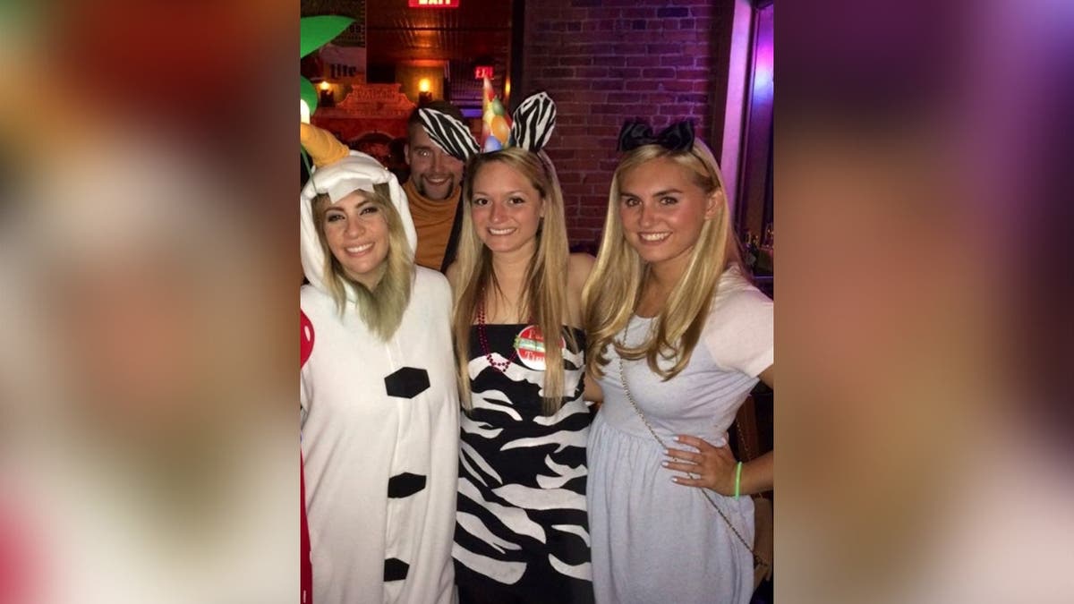 Brooke Hanlon and two friends pose together wearing costumes.