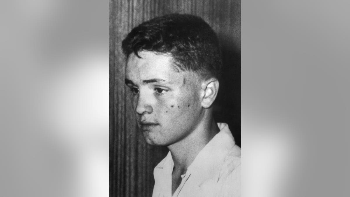 Charles Manson as an adolescent looking away from the camera.