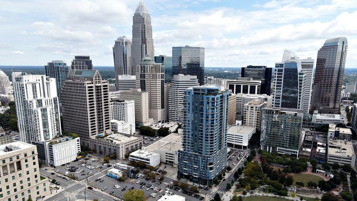 Aerial view of downtown Charlotte skyline under clear skies.