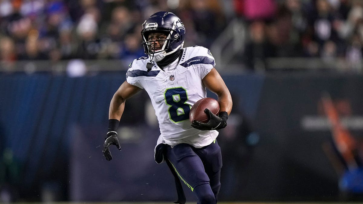 Coby Bryant carries the ball during an NFL game between the Seattle Seahawks and Chicago Bears.