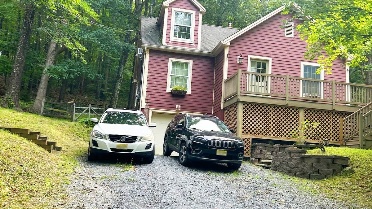 image shows cars parked outside a home