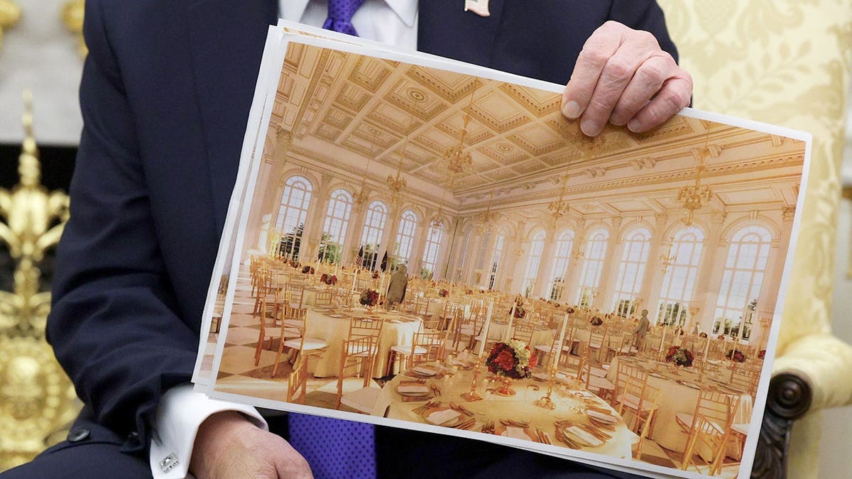 U.S. President Donald Trump holding a rendering of a proposed White House ballroom in the Oval Office