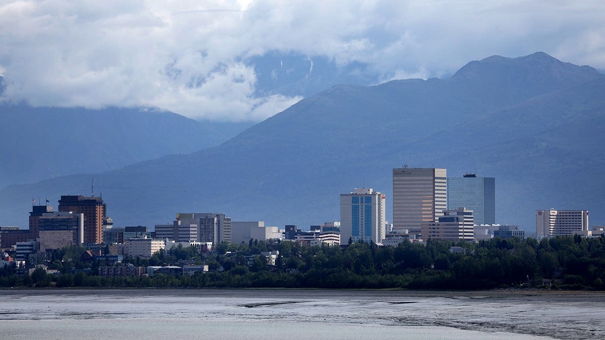 Downtown Anchorage skyline with mountains in the background.