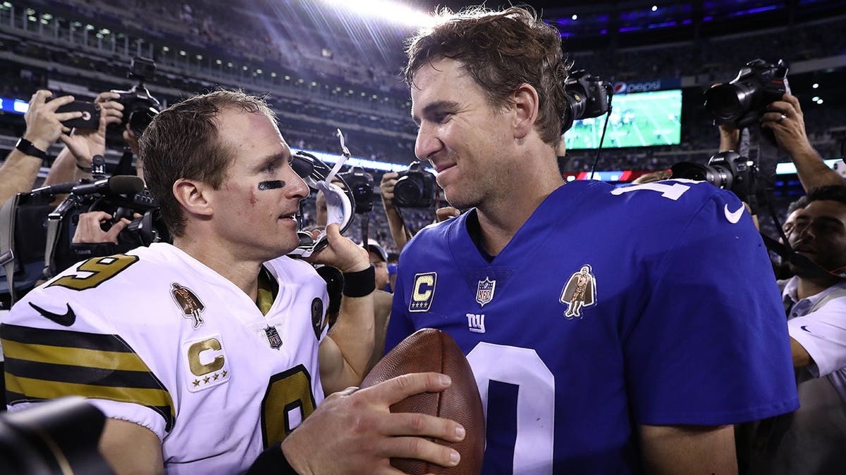 Drew Brees and Eli Manning meet after their game at MetLife Stadium.