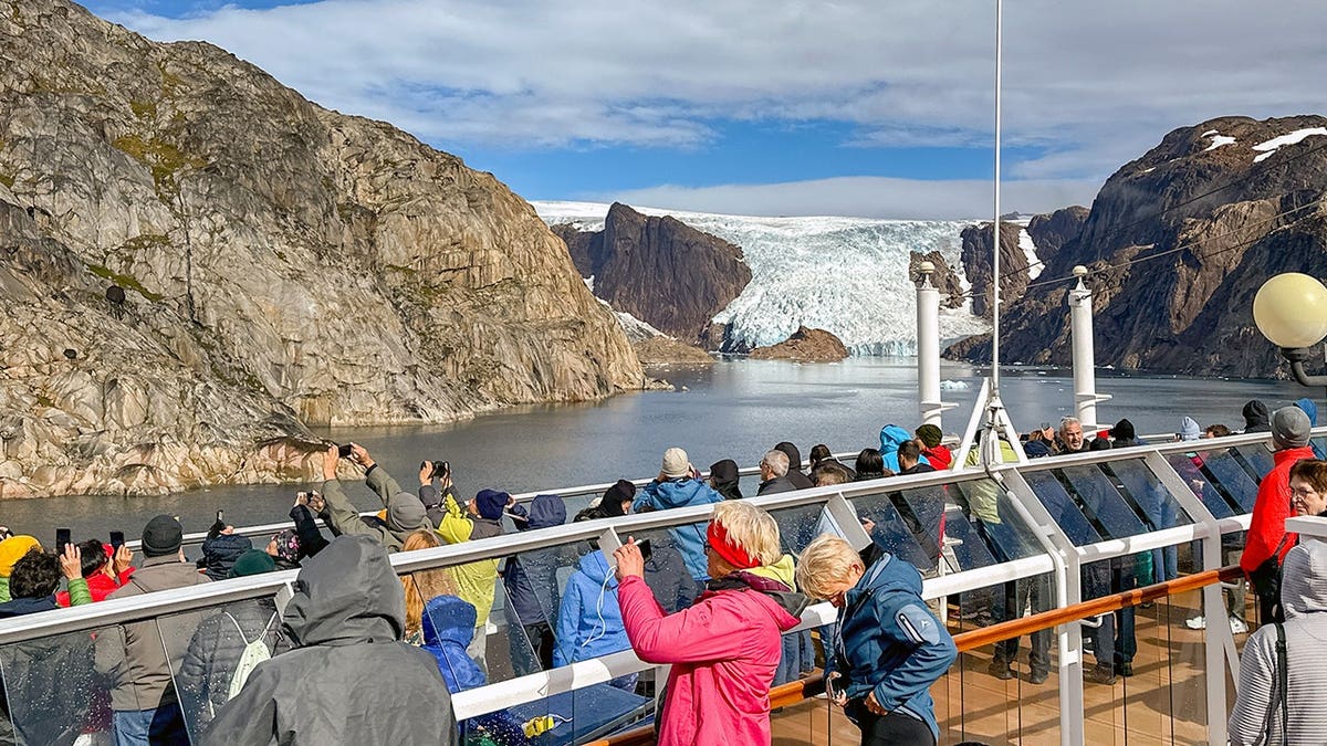 Cruise ship passengers view a glacier in Prince Christian Sound, Greenland.