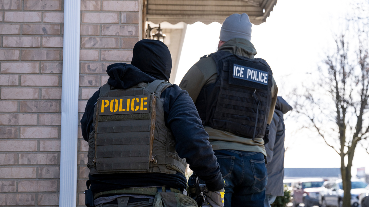ICE agents approach a home in Chicago, Illinois