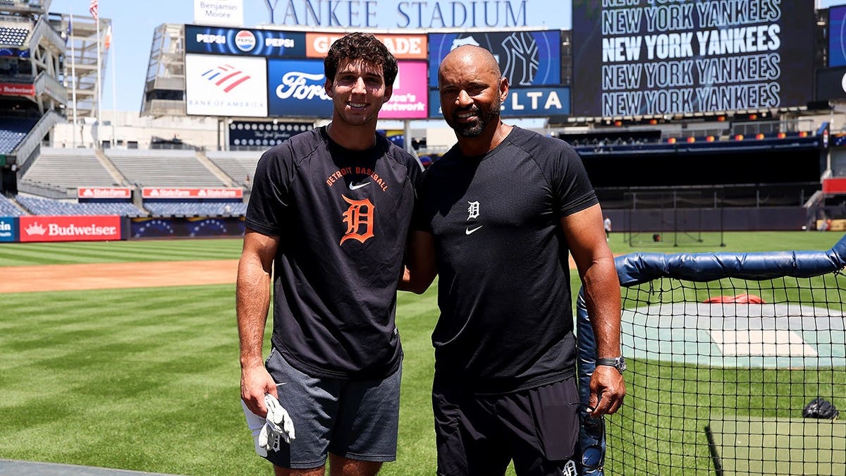 Jacob Lombard and George Lombard Sr. pose for a photo before a game at Yankee Stadium.