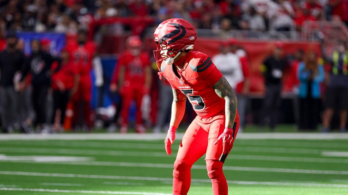 Jalen Pitre waits for play to begin during an NFL game.