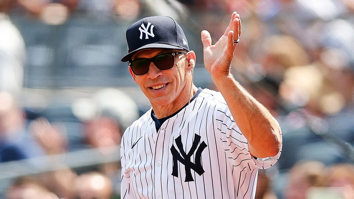Joe Girardi salutes the crowd at Yankee Stadium.