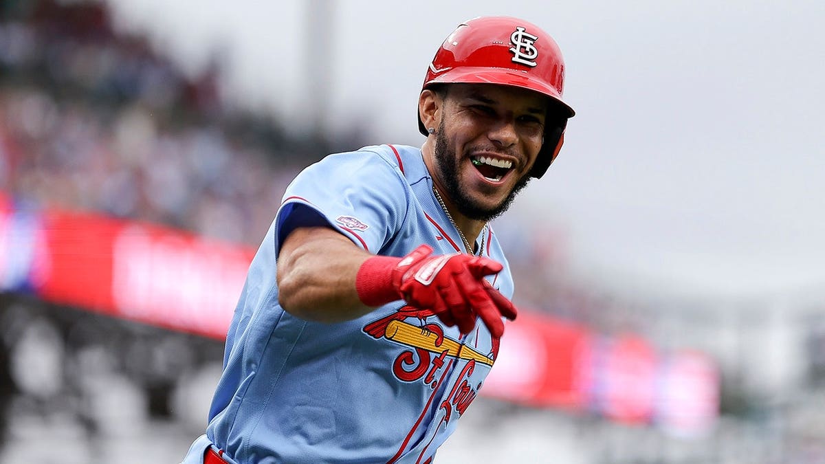 Joshua Báez celebrates after hitting a home run at Wrigley Field.