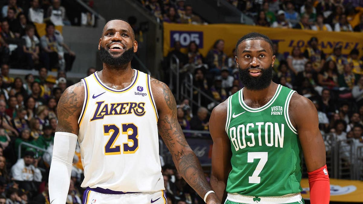 LeBron James and Jaylen Brown look on during an NBA game.